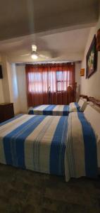 Postel nebo postele na pokoji v ubytování Hotel Corona Zihua + 8 fotografií