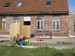 two children playing in front of a brick building at in Den Akker in Oudenaarde