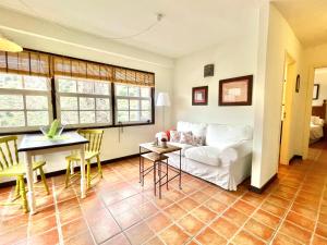 a living room with a white couch and a table at Apartamentos Los Telares in Hermigua