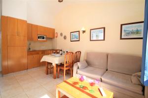 a living room with a couch and a table at Apartaments Talayot in Cala en Blanes