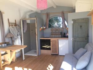 a living room with a table and a kitchen at Lodge Montagnac in Montagnac