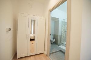 a bathroom with a toilet and a glass door at Central Home B&B in Cosenza