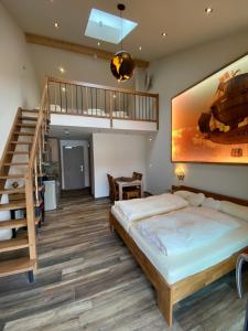 a bedroom with a large bed and a staircase at AVALON ideal gelegen zwischen Europapark und Rulantica in Rust