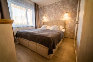 a bedroom with a large bed with a window at Otepää Holiday Apartment in Otepää