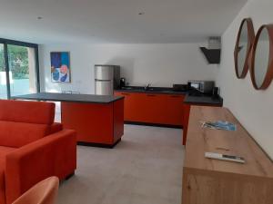 a kitchen with orange cabinets and a wooden table at VILLA FLORENTINA in Saint-Raphaël