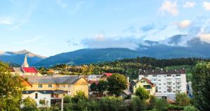 a city with buildings and mountains in the background at Hotel Corina in Borsa