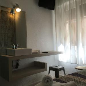 a bathroom with a sink and a mirror at RoomConcept Hostel in Santo Domingo de la Calzada