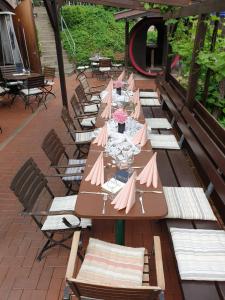 a long table with pink tables and chairs at Gästehaus Brinks in Bad Sassendorf