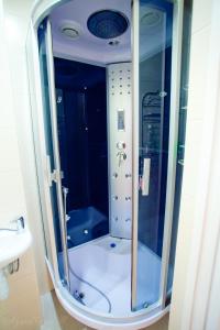 a shower with a glass door in a bathroom at Гостевой дом У Ольги in Suzdal