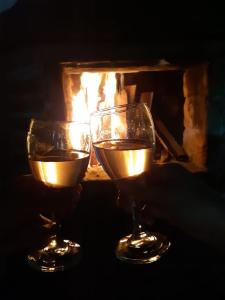 two glasses of wine in front of a fireplace at Finca Formentera, este tu pequeño paraíso in Dosquebradas