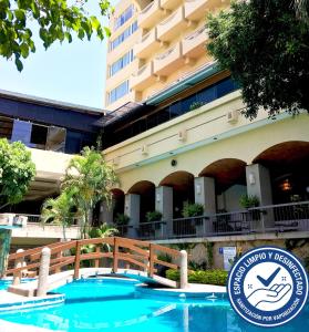 a hotel with a sign in front of a building at Hotel Fortin Plaza in Oaxaca City