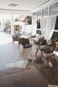 a patio with chairs and a couch and a table at Hotel Orion in Vodice