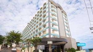 a tall white building with blue accents at Vila Galé Salvador in Salvador