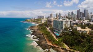 an aerial view of a city and the ocean at Vila Galé Salvador in Salvador