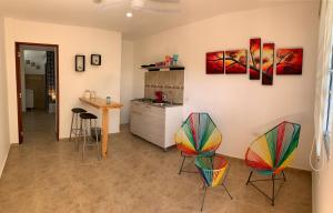 a kitchen with colorful chairs and a counter at Casa Antonella SM in Santa Marta