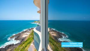 a view of the ocean from the window of a building at Vila Galé Salvador in Salvador