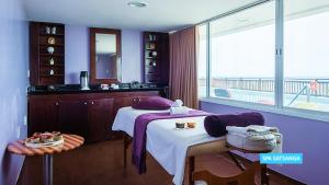 a room with a bed and a view of the ocean at Vila Galé Salvador in Salvador