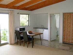 Una cocina y un comedor con mesa y sillas. en 2 Views at Tasman, en Tasman