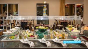 a buffet table with a bunch of food on it at Vila Galé Salvador in Salvador