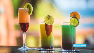 three cocktails sitting on top of a table at Vila Galé Salvador in Salvador