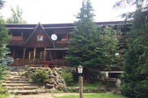 a log cabin with stairs leading to it at Cabana Ignis in Baia Mare