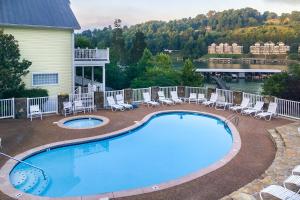 a large swimming pool with chairs and a house at Lake Casa in Norris