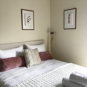 a bedroom with a bed and two pictures on the wall at Stergios_Apartments 05 in Kozani