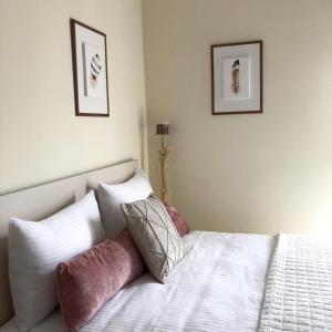 a bedroom with a bed with two pictures on the wall at Stergios_Apartments 05 in Kozani