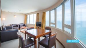 a room with a table and chairs and a large window at Vila Galé Salvador in Salvador