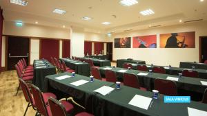 a conference room with tables and chairs in it at Vila Galé Salvador in Salvador