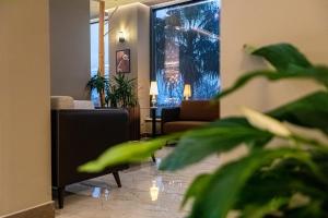 a living room with a couch and a table at Kraal Hotel Vlore in Vlorë