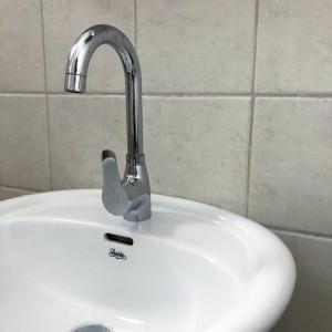 a white sink with a faucet in a bathroom at Stergios_Apartments 03 in Kozani