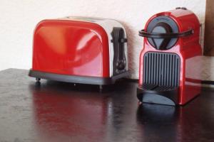 a red toaster sitting on top of a table at Val Thorens 2 bedrooms 6 persons next slopes in Val Thorens