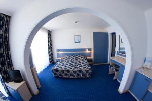 a hotel room with a bed and an archway at Palace Hotel in Sunny Beach +95 photos