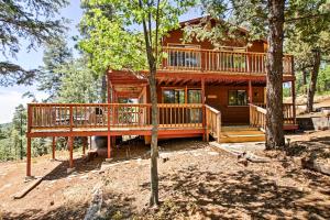 a large log home with a large deck in the woods at Prescott Forest Cabin with Deck, 9 Miles to Downtown in Prescott