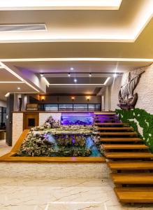 a staircase in a lobby with a water fountain at Kraal Hotel Vlore in Vlorë