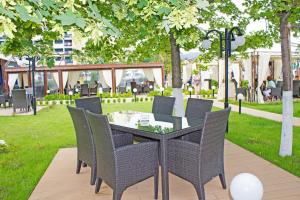 a group of chairs and a table in a park at Palace Hotel in Sunny Beach