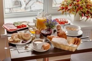 a breakfast table with breakfast foods and drinks on it at Solo Prima in Saint Petersburg