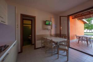 a kitchen and dining room with a table and chairs at Holiday home in Sirmione - Gardasee 38480 in Sirmione