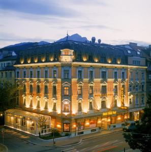 un gran edificio en una ciudad por la noche en Hotel Neue Post I self check-in, en Innsbruck