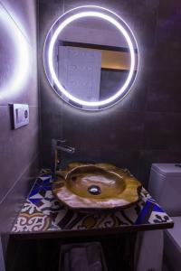 a bathroom with a wooden sink and a mirror at Casa Rural El Portillo in Cantavieja