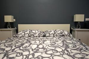 A bed or beds in a room at The Photos Room B&B
