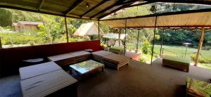 a patio with a couch and chairs and a table at Playa Selva Lodge in Archidona