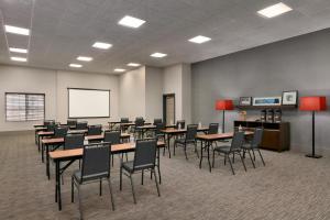 a conference room with tables and chairs and a whiteboard at Country Inn & Suites by Radisson, London, KY in London +55 photos