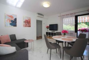 a living room with a couch and a table with chairs at Apartment in Porec/Istrien 40339 in Poreč