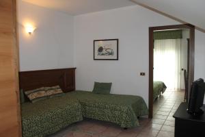 Giường trong phòng chung tại Residence La Piscina