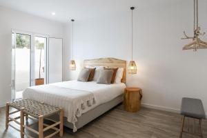 Кровать или кровати в номере Pé no Campo Suites and Villa