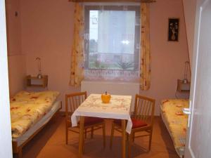 a room with two beds and a table and a window at Holiday home in Ruda 2035 in Ruda