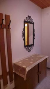 a mirror on a wall next to a wooden bench at Apartments in Kaltenbach/Zillertal 751 in Kaltenbach