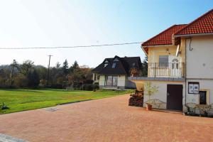 a house with a brick driveway in front of a house at Holiday home in Balatonalmadi 38980 in Balatonalmádi